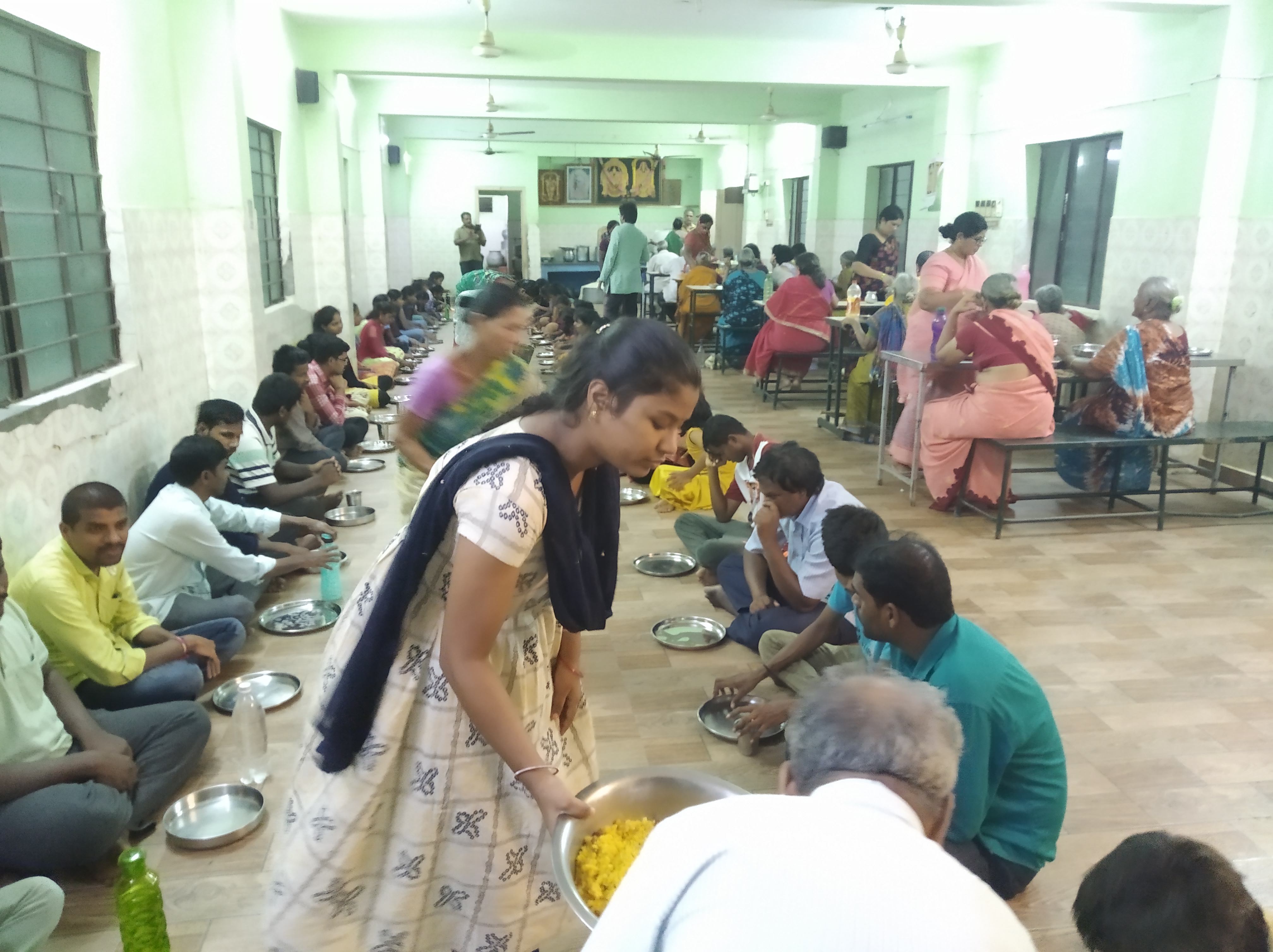 SHE volunteers visiting a household with children
